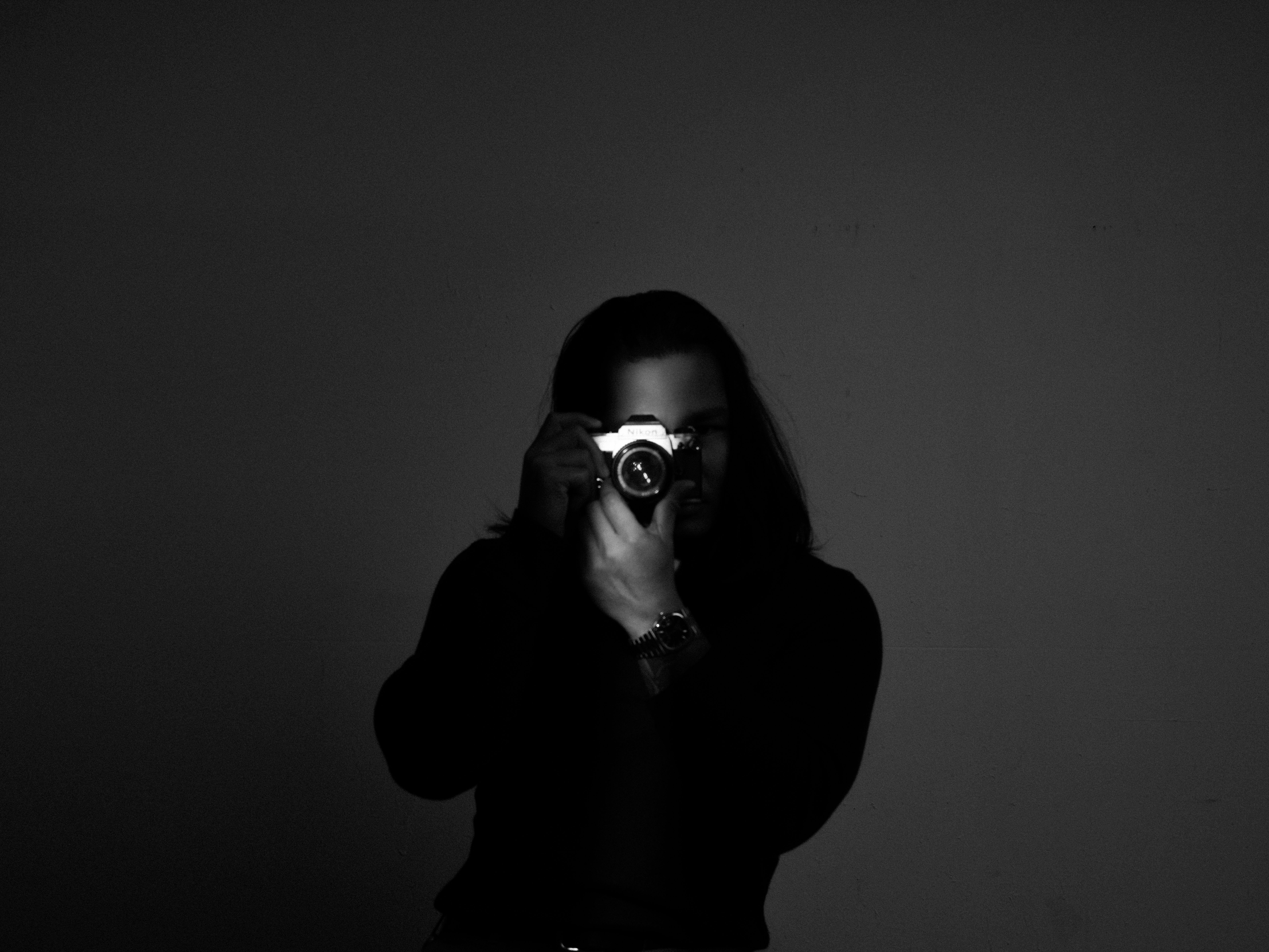 Khai Nguyen holding a Fuji film camera up to his eye